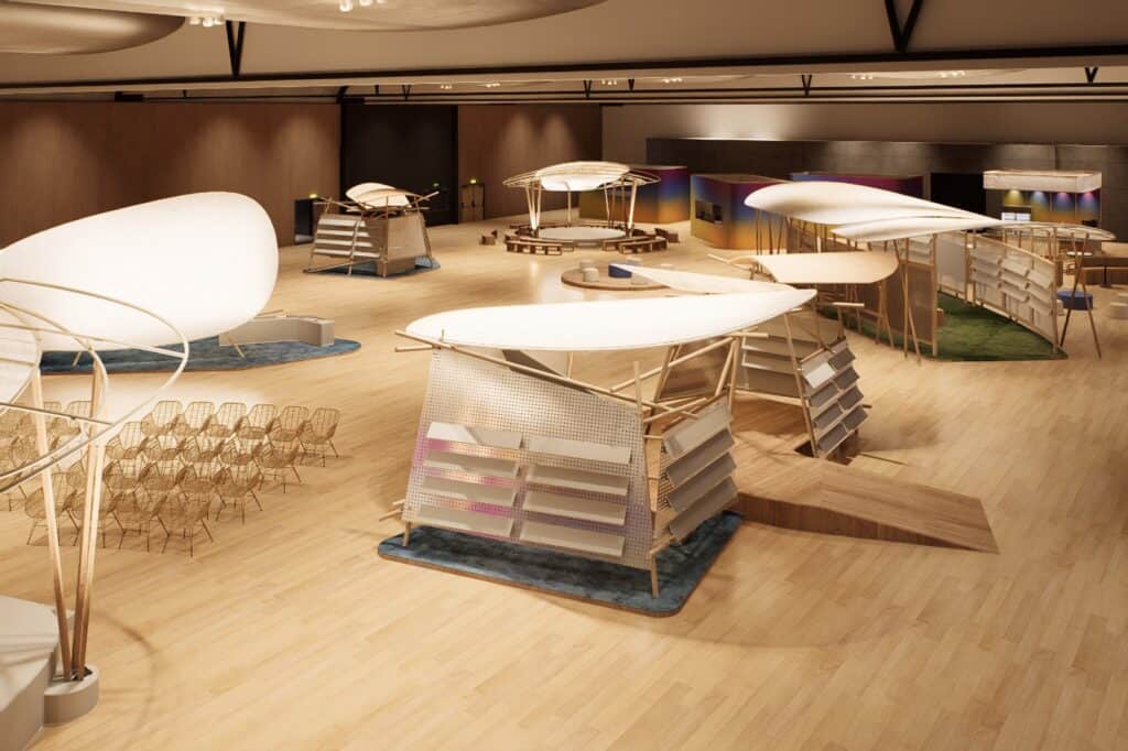 An indoor exhibition space with modern, sculptural booths, seating areas, and wooden flooring, viewed from above.