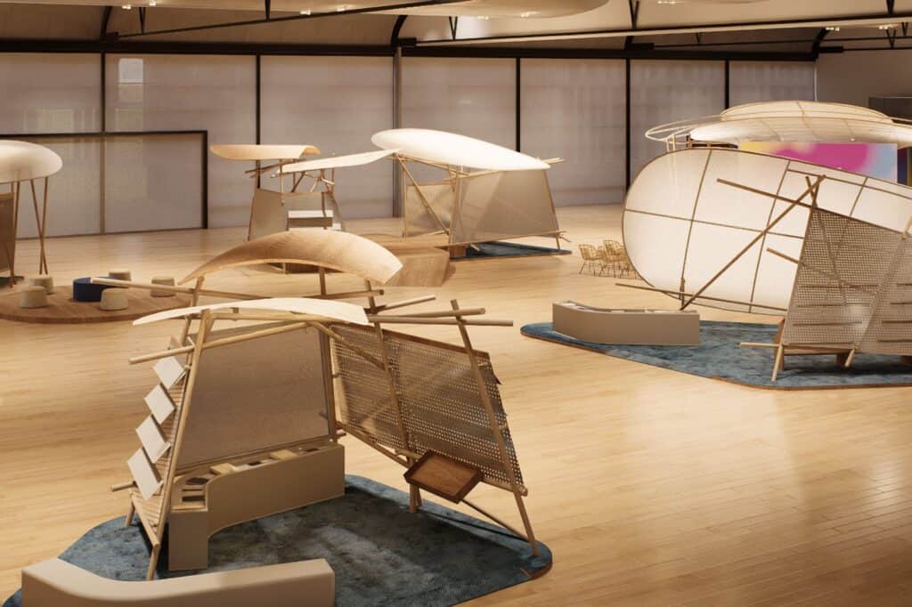 A spacious room with wooden floors featuring several large, abstract, light-colored sculptural installations made of wood and fabric.